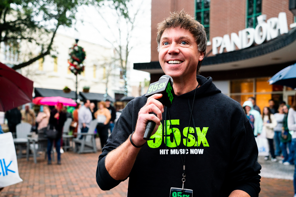Man Holding Microphone at The BIG Give Black Friday Gift Card Giveaway