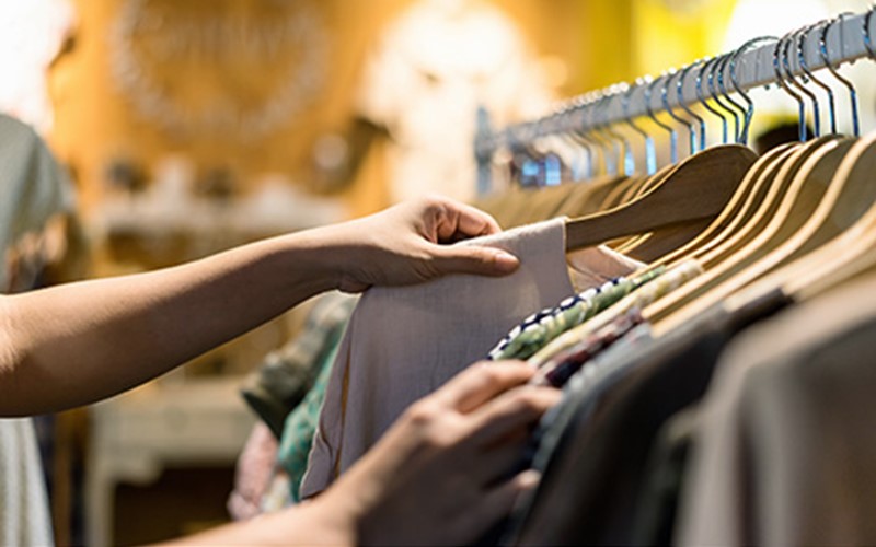 Person choosing clothing from a rack